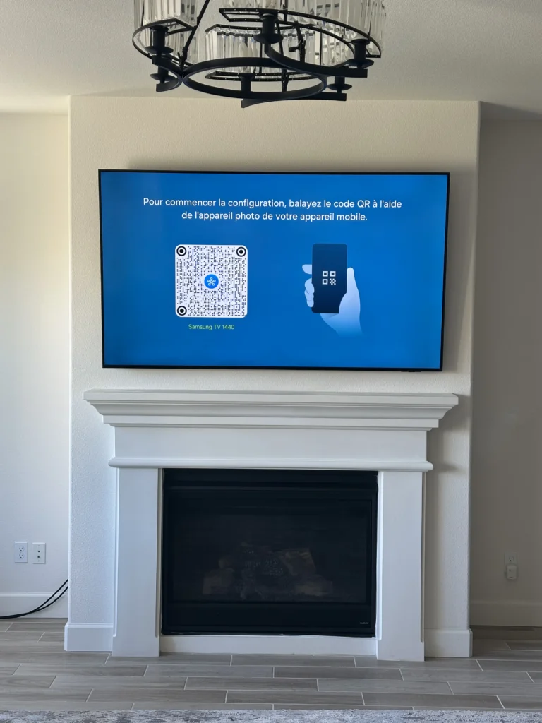 TV above a fireplace with a white mantel. No cables showing.