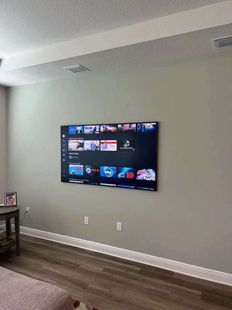 TV on a drywall wall in a family room. No cables showing.
